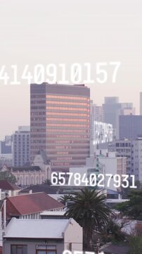 Animation of changing numbers over aerial view of modern buildings in background