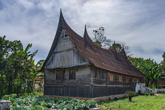 Traditional Rumah Gadang wooden house in Bukittinggi, West Sumatra, Indonesia, featuring the distinctive curved roof architecture and cultural heritage of the Minangkabau people