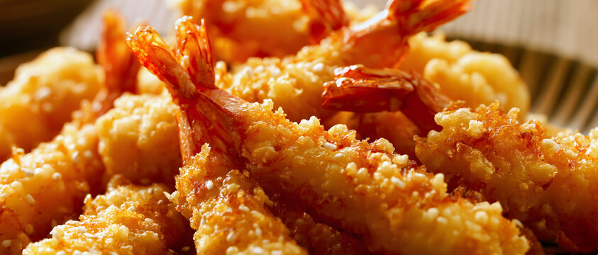 Fried shrimp with golden brown batter and visible tails close up food photography battered breaded breading crust deep fried foodie golden brown gourmet lunch meal