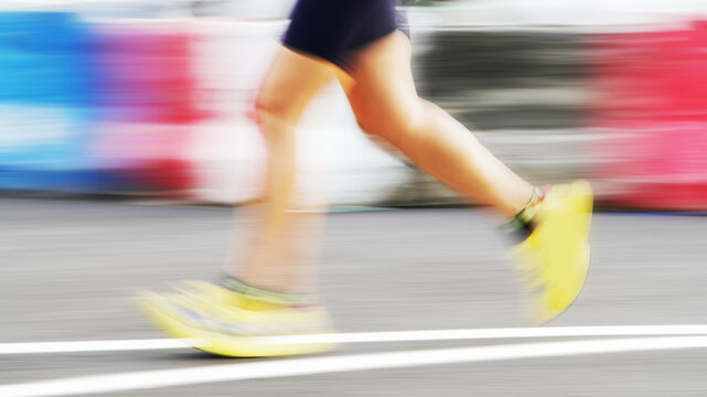 Runner training outdoors with blurred surroundings to convey speed and active lifestyle