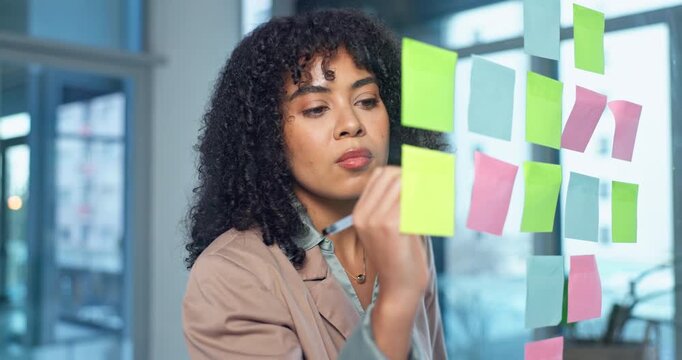 Woman, writing and planning with sticky note in office for business schedule, agenda or tasks. Female person, employee or brainstorming with ideas for project management or reminder in workplace
