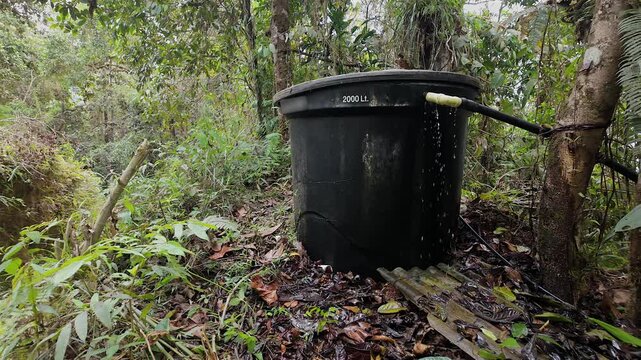overflowing water tank in the forest