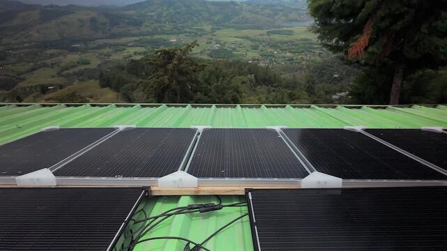solar panels on green roof overlooking colombia mountain valley landscape