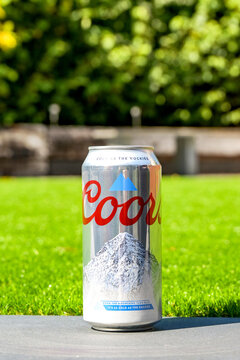 Cardiff, Wales, UK - 9 August 2026: Unopened can of chilled Coors light beer isolated on the wall of a garden patio.