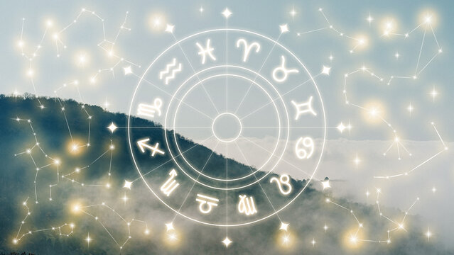 Astrology zodiac signs displayed on a cloudy mountain background during daylight