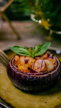 Close up view of gourmet stuffed mushrooms garnished with fresh basil leaves, suggesting fine dining preparation or healthy appetizer ideas, perfect for culinary blogs