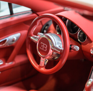 Gothenburg, Sweden - May 30 2026: Red Bugatti steering wheel closeup inside elegant exotic sports car.