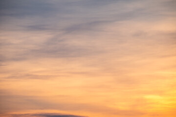 Obraz premium Sky sunset,Beautiful sunrise sky with vibrant gradient orange and gold colors and soft blue, Clear atmosphere with wispy clouds. Peaceful, perfect for background and copy space, High resolution images