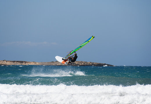 a windsurfer riding the waves at sea, Prasonisi Peninsula (Rhodes, Greece)