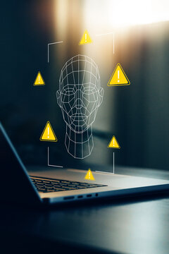 Deep fake technology warning displayed on a laptop screen with a digital face outline