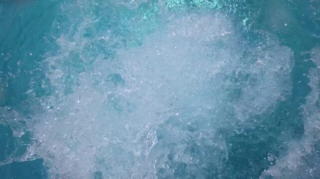 Turquoise water churning and bubbling at pool