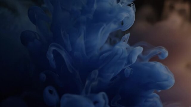 Abstract swirling blue ink cloud in water