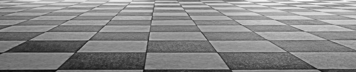 Fototapeta premium Black and white checkered floor tiles. Classic geometric pattern on polished stone. Clean lines define each square tile. Ideal for interior design projects. Subtle wear adds character to surface