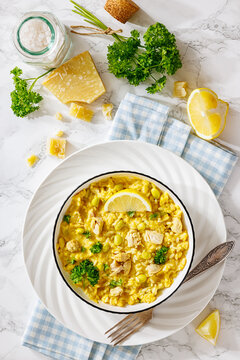 Creamy saffron chicken risotto in a bowl, top view