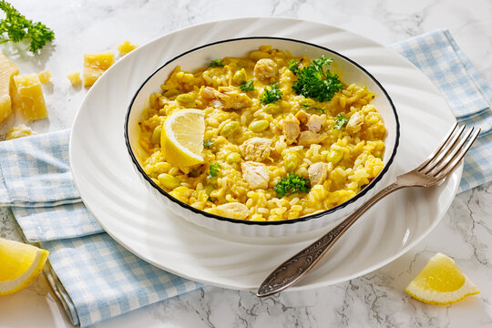 Creamy saffron chicken risotto in a bowl, top view