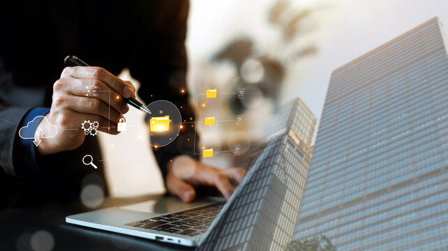 Business professional using a laptop with digital file management, cloud storage, data security and document technology concepts, ideal for enterprise, cybersecurity and workflow solutions.