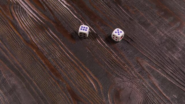 Close-up of dice being thrown on a wooden table