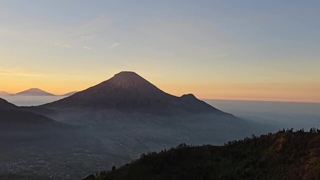 Beautiful view of mountains and morning sun on Sikunir Hill Dieng, This is Golden Sunrise which is Sikunir's favorite. Perfect serene landscape background for travel, morning and nature media.