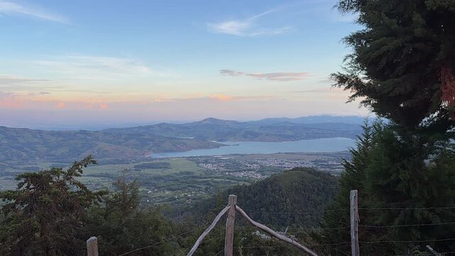 sunset over scenic mountain lake and valley landscape