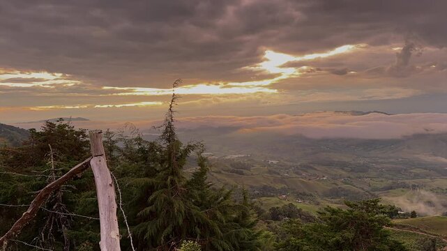 scenic sunset landscape with dramatic clouds and mountain valley view
