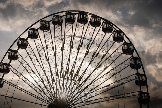 Silhouette of a Ferris Wheel at Sunrise