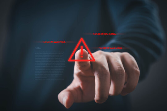 Cybersecurity warning featuring a hand pressing a digital alert icon, representing system security, cyber threat detection, risk management, data protection, network monitoring, incident response.