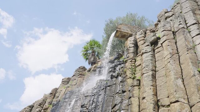 Water cascading down the unique volcanic rock formations of the basaltic prisms of santa maria regla