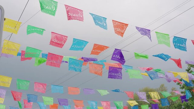 Traditional colorful paper banners fluttering against a gray sky in huasca de ocampo, hidalgo, mexico