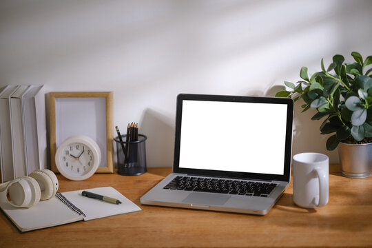 Minimal remote work desk setup featuring laptop mockup, headphones, notebook and office accessories, ideal for productivity and technology concepts.