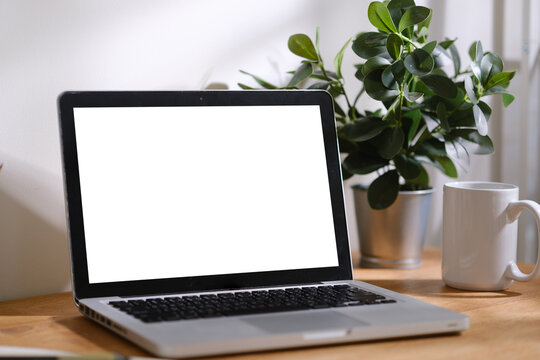 Minimal remote work desk setup featuring laptop mockup, headphones, notebook and office accessories, ideal for productivity and technology concepts.