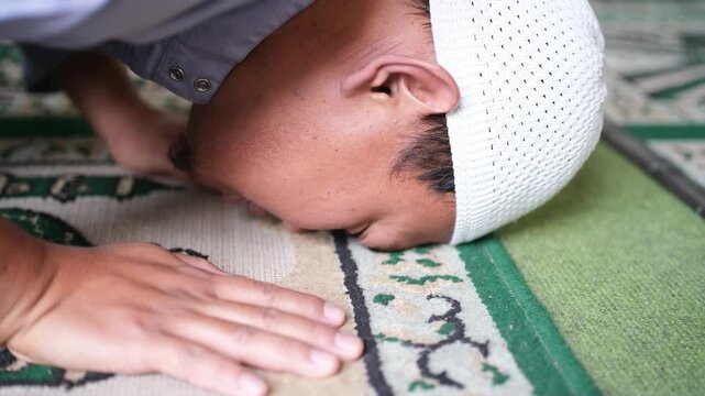 Closeup of head position when prostrating in prayer. Prostration movement in prayer. The form of humbled oneself to God. Muslim worship.