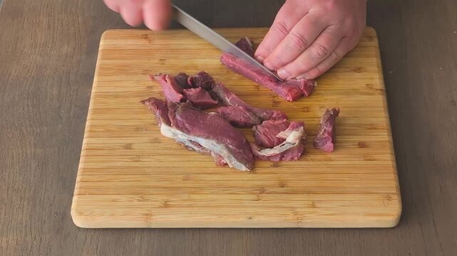 Slicing meat tenderloin into even pieces for cooking and serving