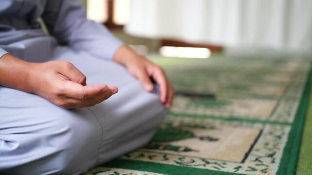 A close-up of a person reciting dhikr with their hands, counting on their fingers. A symbol of spiritual practice and devotion. Islam. A Muslim. 
