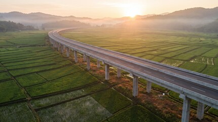 Fototapeta premium Aerial Scenic Highway Bridge Crossing Green Agricultural Fields at Golden Sunrise