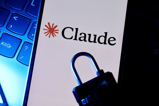 Salvador, Brazil - August 12, 2026: Claude app logo on smartphone screen next to a padlock. AI security, digital credibility, and watermark concepts.