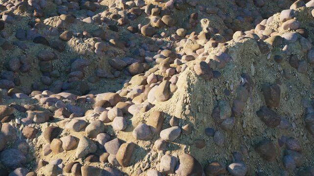 A rocky sand field rolls softly like ocean waves in a continuous loop. Great for abstract backgrounds, textures, and atmospheric visuals. 3d render animation.