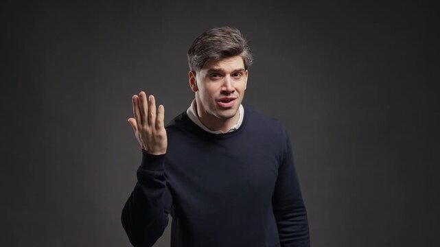 Young Adult Man Pointing To His Ear With Confused Expression, Signaling He Cannot Hear Clearly, Male Reacting To Audio Problems, Miscommunication, Noise Or Hearing Difficulty