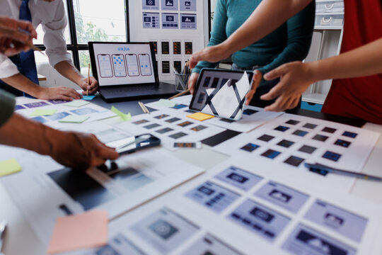 Team of designers and developers collaborating on user experience and user interface design for a new mobile application