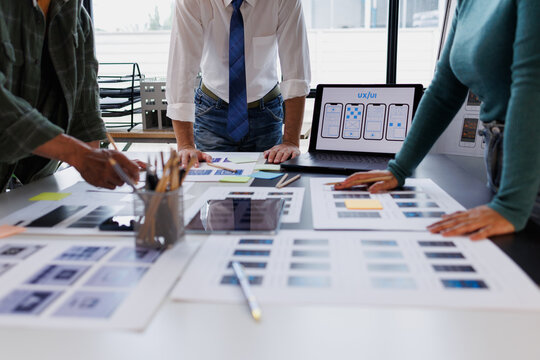 Ux ui designers collaborating on web application wireframes, planning interface design and user experience