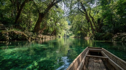 Fototapeta premium A tranquil boat journey down a clear river surrounded by lush, vibrant green forest. The water's surface reflects the dense foliage, creating a sense of serenity and immersion in nature