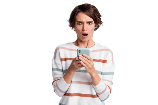 Photo of sad impressed young woman dressed striped pullover looking holding modern device isolated grey color background