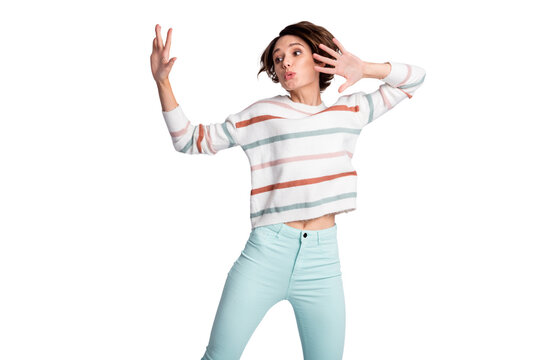 Photo of pretty shiny young woman dressed striped pullover dancing rising arms isolated grey color background