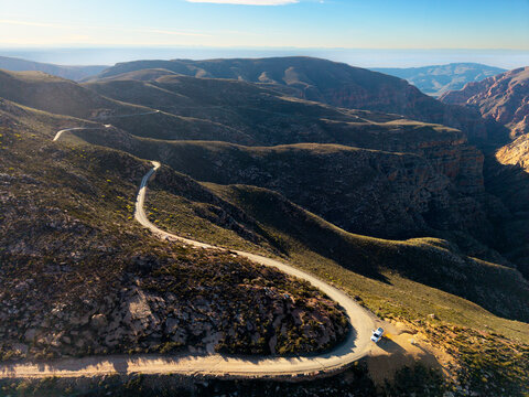 Aerial of winding dirt road mountain pass, Swartberg pass, South Africa