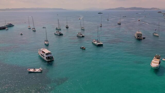 Panoramic, aerial view of the turquoise bay with yachts and boats off the coast of Santa Maria Island in the La Maddalena archipelago, Sardinia, Italy
