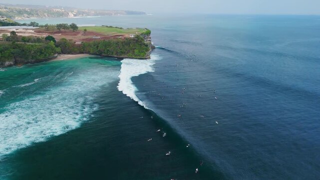 Aerial view with ocean waves and surfers in ocean on Balangan beach. Surfing and waves