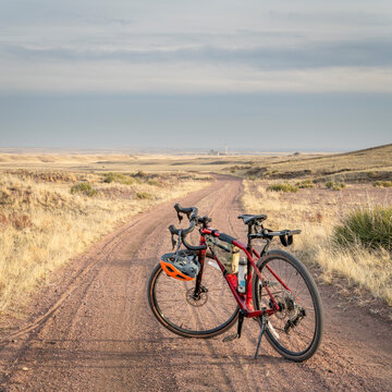 gravel bike on a dirt road in Colorado prairie - Sand Wash trail in Soapstone Prairie Natural Area near Fort Collins, Colorado