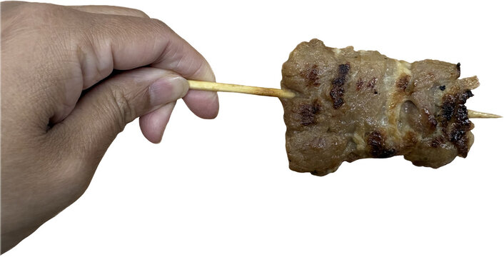 Isolated A hand holding a grilled pork skewer., moo-ping, pork barbecue grilled stick, Thai barbecue on isolated white background 