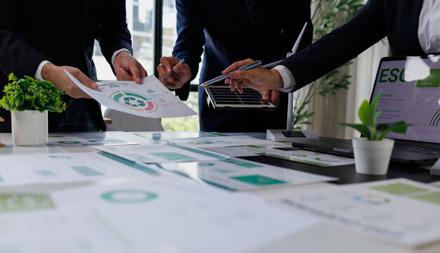 Business team discussing esg strategy and sustainability report during corporate meeting, planning environmental impact