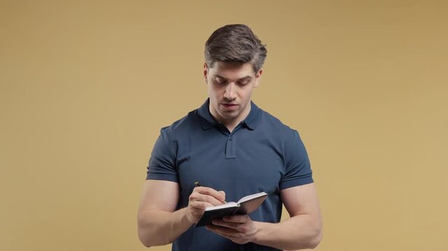 Adult man Writing Future Plans In Planner, handsome guy Taking Notes In Notebook, Creating A To Do List And Organizing Weekly Tasks, Office And Student Lifestyle