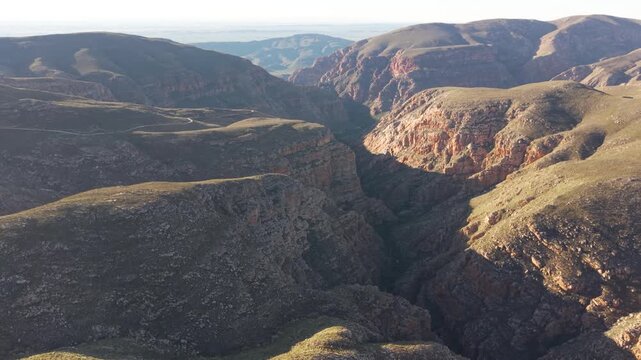 Aerial of winding dirt road mountain pass, Swartberg pass, South Africa